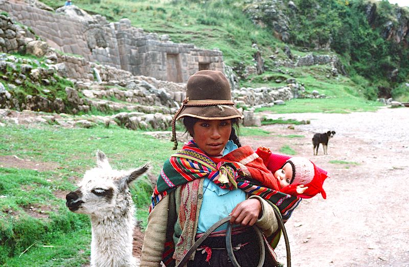 Peruvian girl with pet llama at Machu Pichu, Peru